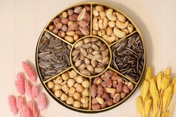 Mixed nuts, peanuts, kernels and cashews on wooden background, top view. Healthy snack - organic...