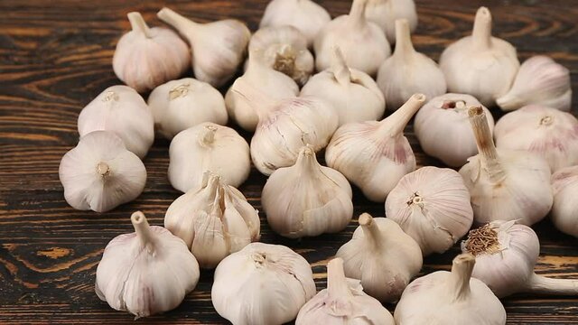 Heap of fresh garlic on wooden background