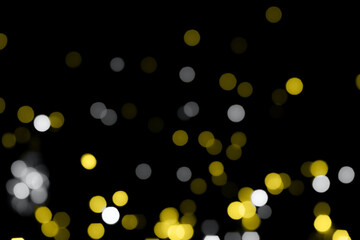 Photo of the texture sparkles bokeh in grey and yellow illuminating colors. Color year 2021.