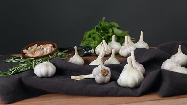 Fresh garlic and herbs on wooden table