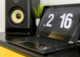 Selective focus shot of a music column, a flip clock screensaver showing the timecreen