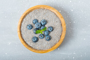 chia pudding with blueberries in a wooden plate