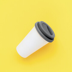 White bamboo coffee to go cup with a grey color silicone lid on a yellow background