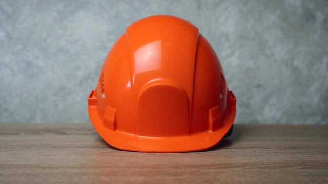 orange workman's helmet is on the table.