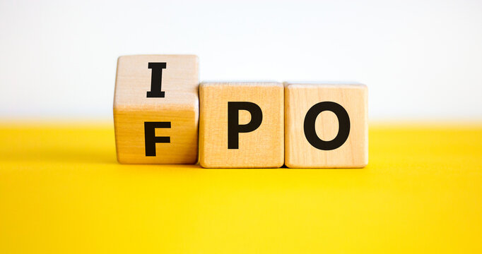 IPO vs FPO. Turned a cube and changed the word 'IPO - initial public offering' to 'FPO - follow on public offer'. Beautiful yellow table. White background. Business and IPO vs FPO concept.