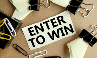 enter to win. word. text. on white paper on craft background on wood table
