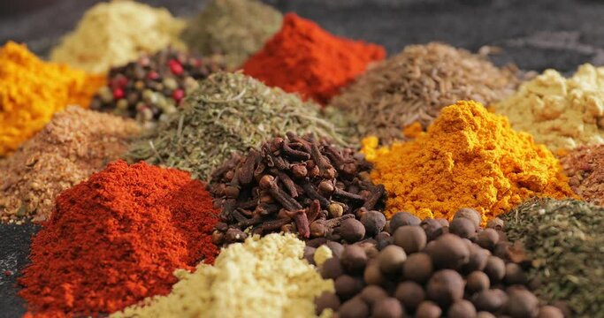 Different spices on dark background, closeup