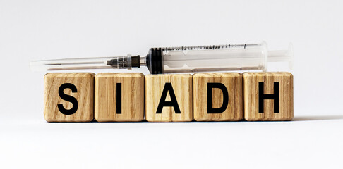 Text SIADH made from wooden cubes. White background