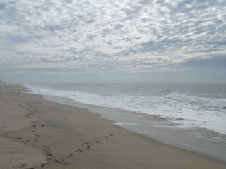 Empty beach in the afternoon, sky all covered with clouds, Praia da Amorosa, Portugal