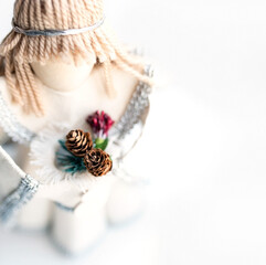 Light Christmas background with blurred toys and cones on white background