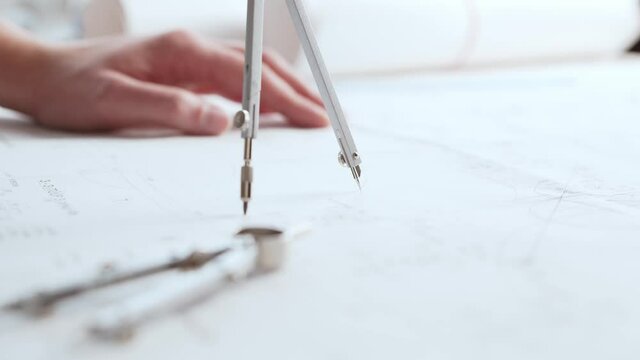 Close-up of an architect's hands. Professional real estate designer at the workplace in the office.