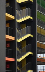 bright yellow external fire escape of new multilevel parking building