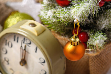Fototapeta na wymiar retro alarm clock and decorated christmas tree - new year or holiday decoration