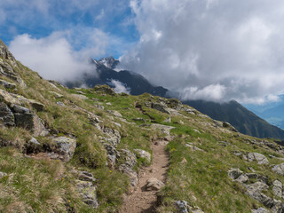 Summer alpine mountain landscape with footpath of Stubai hiking trail and snowy mountain peaks, Stubai Hohenweg, Tyrol Alps, Austria