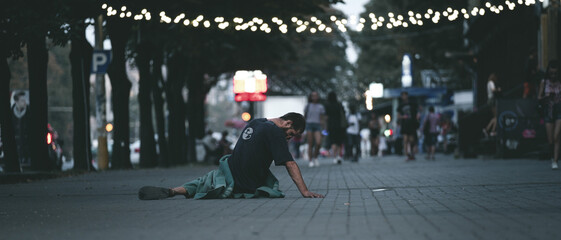 Homeless Man Covered With Blanket On Street In City. Homeless man closed face,  suffering...