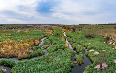 Small fast stream Kamenka in the evening light in Ukraine