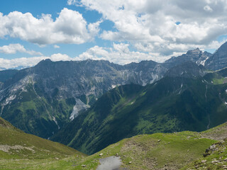 view from Pramarnspitze saddle on snow-capped moutain panorama at Stubai hiking trail, Stubai Hohenweg, Alpine landscape of Tyrol Alps, Austria. Summer blue sky, white clouds