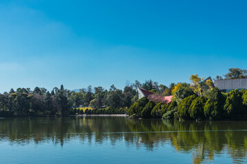 Fototapeta na wymiar A beautiful view of a lake on a sunny day. A view of Bosque de Chapultepec, the biggest park in Mexico City and one of the biggest city parks in the world