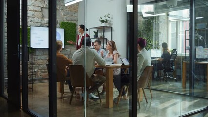 Office Conference Room Meeting: Female Chief Executive Talking to a Diverse Team of Professional Businesspeople. Creative People Listen to CEO Discuss Design, Data Analysis, Plan Marketing Strategy