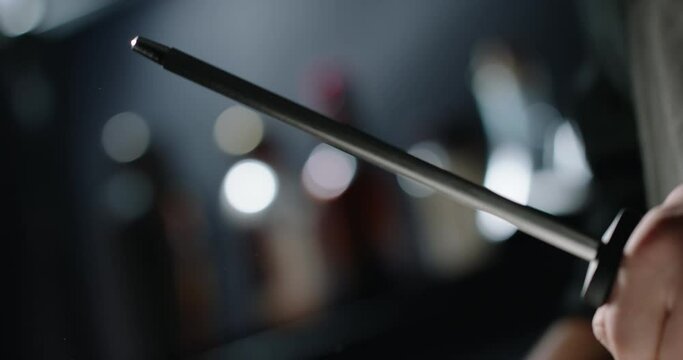 Close up shot of chef sharpening a cool knife before cutting meat or making a meal. Professional cooker preparing an instrument for work 4k footage
