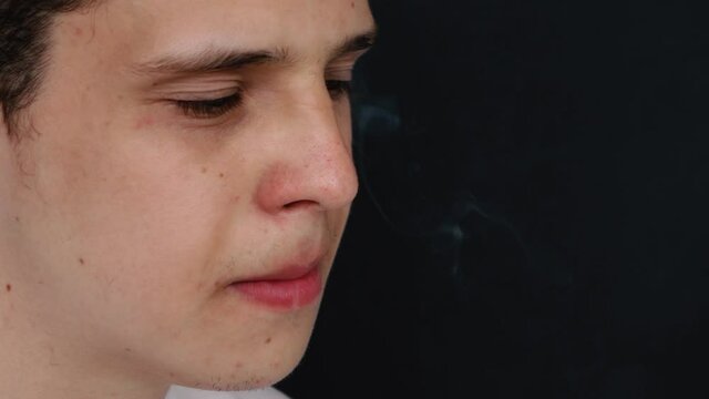 man smokes a cigarette. slow motion.