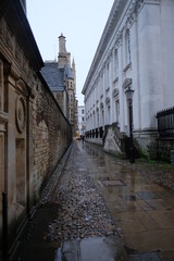 Cambridge UK December 2020 Narrow Senate House Passage street leading among the ancient buildings in the center of cambridge city, empty on a cold rainy december day
