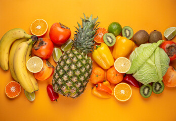 Fototapeta na wymiar Fruit, citrus, vegetables with vitamin C, yellow orange background top view. Vitamin C natural sources for immunity stimulation, against viruses and avitaminosis. Healthy food to boost immune system.