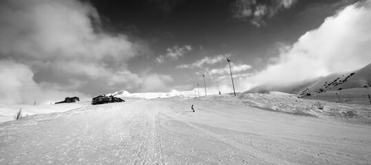 Snowboarder on piste slope in winter day