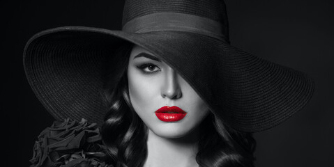 Portrait of a beautiful woman with red lips in a hat, toned in color of the year 2021, ultimate grey.