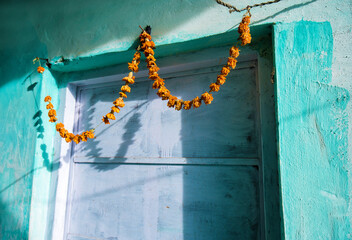 orange flowers hang a garland  ( religious purpose - protection from evil spirits ) or beauty purpose