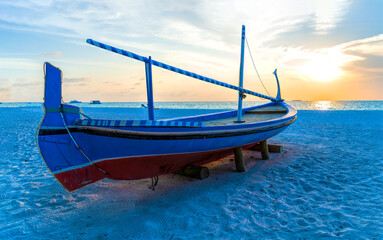 View of nice tropical beach with old boat