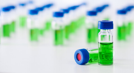 HPLC vials with green sample of plant extracts. Developing of drugs based on natural products....