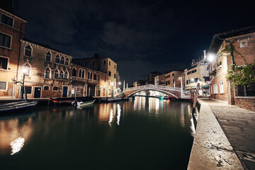 bridge and water view over a canal in Venice at calm night
