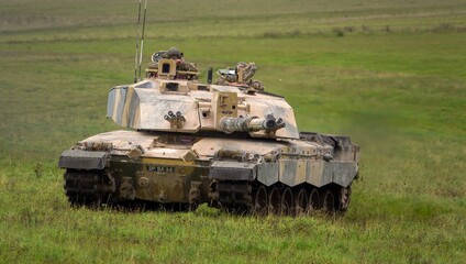Fototapeta premium Action shot of a British army Challenger 2 FV4034 Main Battle Tank on a military exercise, gun aiming toward camera, Salisbury Plain, UK 