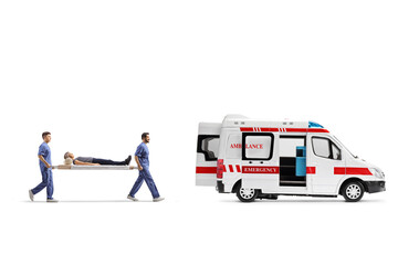 Medical workers carrying a stretcher with a female patient into an ambulance van