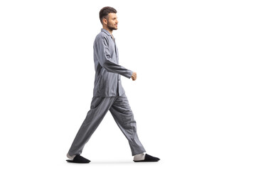 Young man in pajamas walking