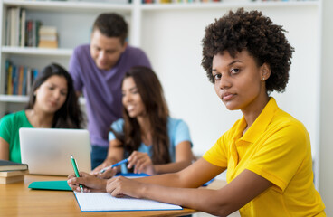 Beautiful afro american female student with group of multi ethnic students