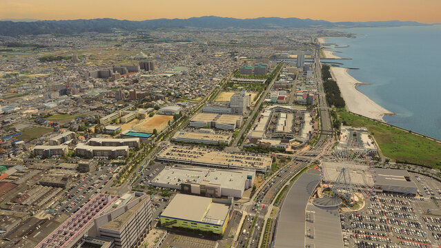 Aerial view or bird eyes view images of Kansai bay area Osaka Japan include big premium outlets located across from Kansai International Airport and it's largest airport in western Osaka bay Kansai