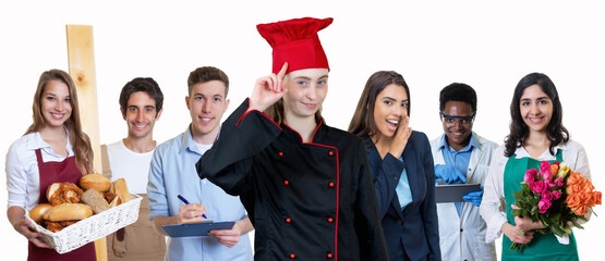 Beautiful young female chef with group of trainees