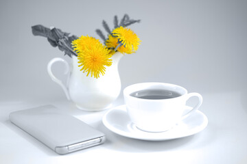 Morning tea with bouquet of yellow spring dandelion flowers. Yellow and gray.