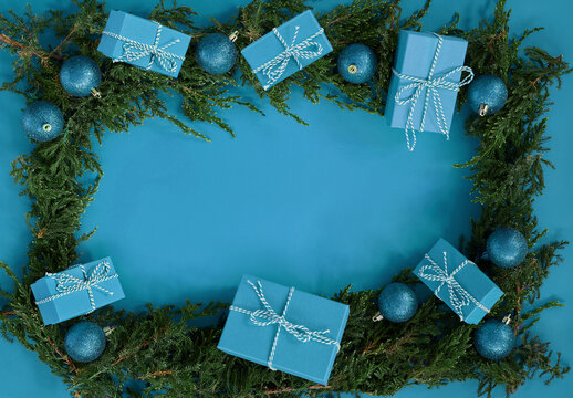 FFlat lay new year Christmas blue boxes, blue balls, pine tree on blue background. High quality photo