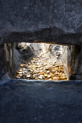 River of coins, stone window