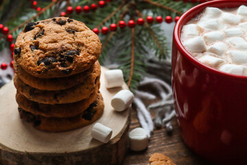 Cozy winter home backround with cookies, hot chocolate and marshmallows. Festive, holiday concept. Close-up, selective focus