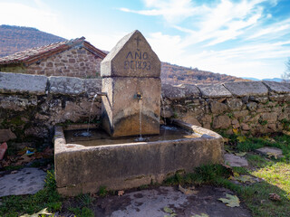 Old fountain with three pipes in the town of Monasterio de la Sierra in the autonomy of Castilla y...