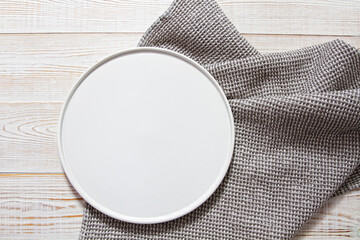 White empty plate mock up on wooden table - top view