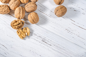 Walnuts kernels on white wooden desk, stock photo