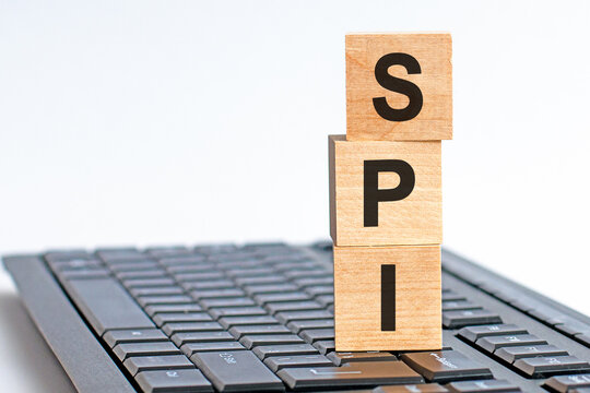 SPI word on wooden block sign on a keyboard