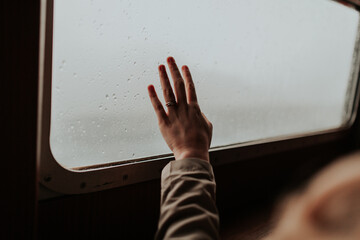 Hand reaching towards window