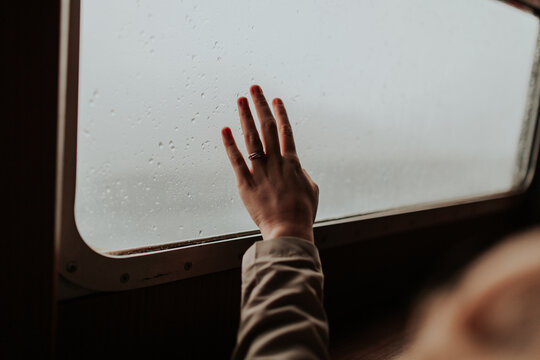 Hand Reaching Towards Window