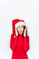 A funny portrait of a woman wearing a Santa hat in Christmas. She is looking at the camera with a surprised face. Christmas portrait concept.